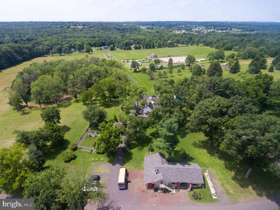 1515 Sugar Bottom Road Furlong, PA 18925 - Photo 86 of 96 an aerial view of green landscape with trees houses and lake view