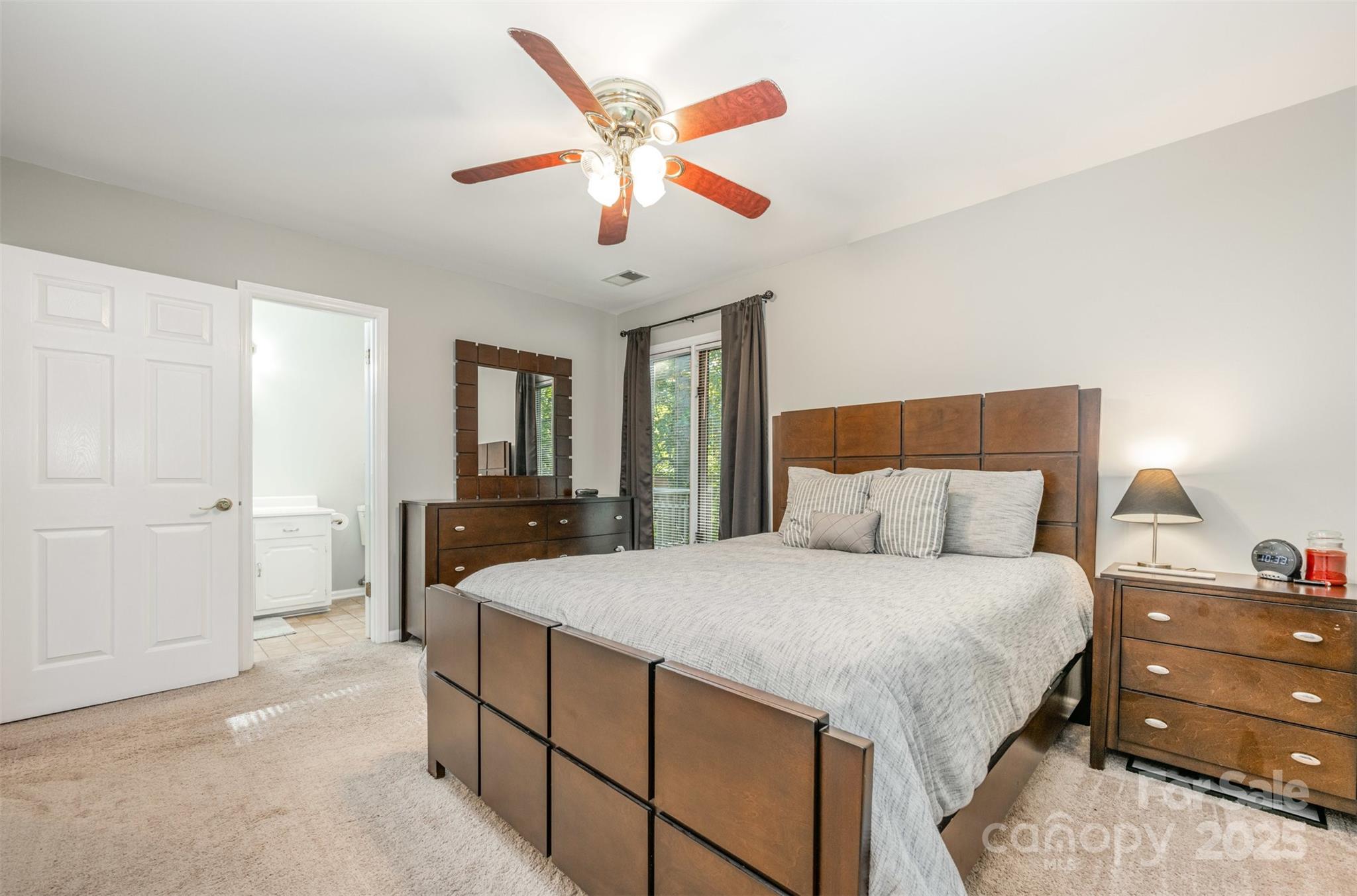 1500 Beth Haven Church Road Denver, NC 28037 - Photo 14 of 35 a bedroom with a large bed and a chandelier