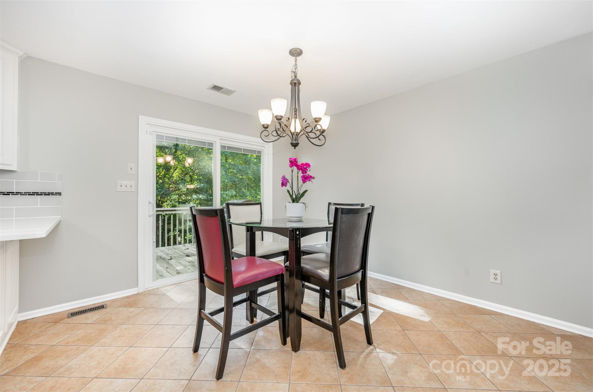 1500 Beth Haven Church Road Denver, NC 28037 - Photo 9 of 35 a dining room with furniture a potted plant and a chandelier
