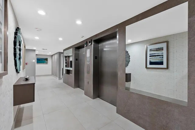 a dining room with wooden floor a chandelier a wooden table and chairs