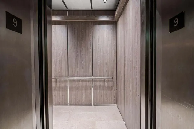 a living room with furniture a large window and a flat screen tv