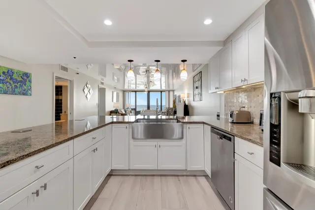 a living room with furniture and floor to ceiling windows
