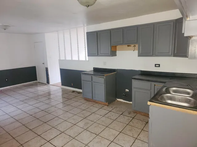 a kitchen with granite countertop a sink and a stove