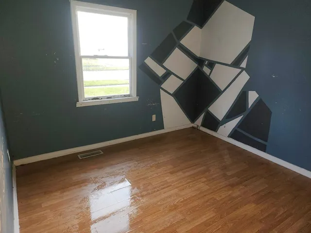 an empty room with wooden floor