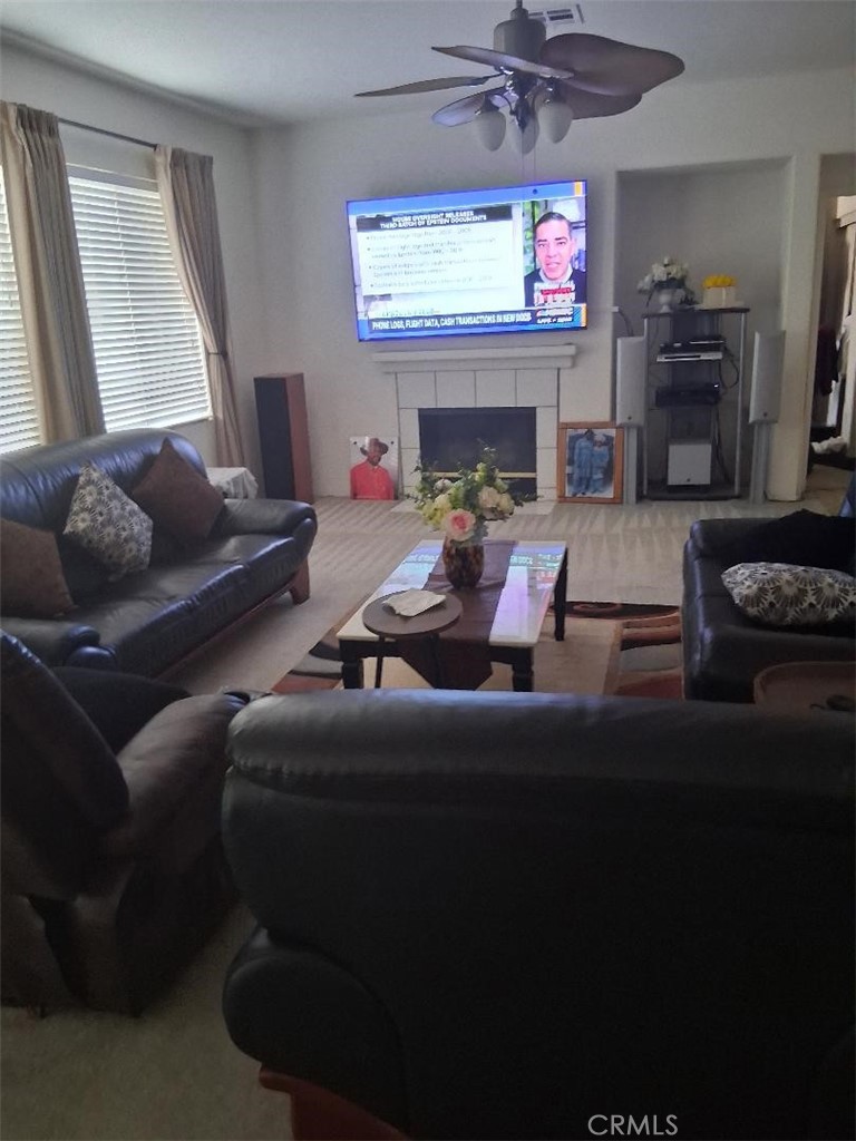 26928 Commons Moreno Valley Moreno Valley, CA 92555 - Photo 3 of 12 a living room with furniture and a flat screen tv