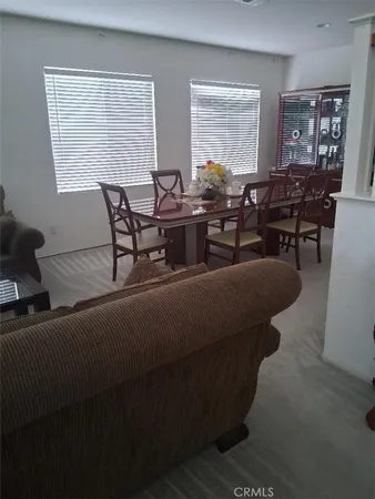 a living room with furniture and large windows
