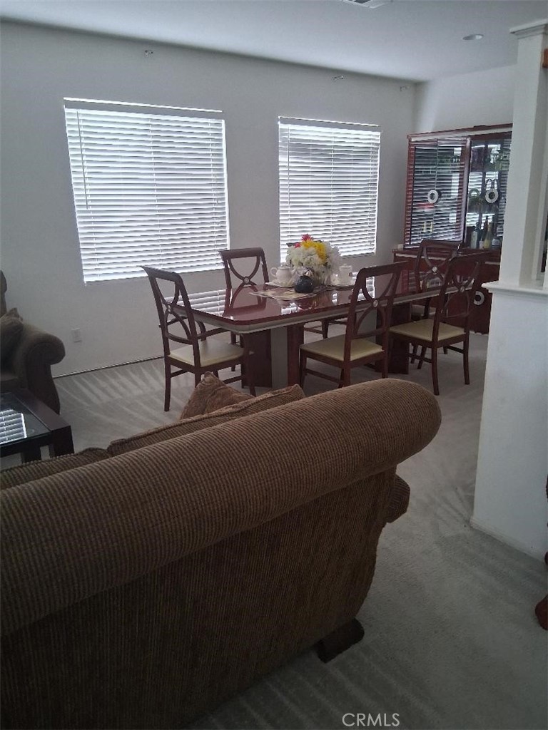 26928 Commons Moreno Valley Moreno Valley, CA 92555 - Photo 5 of 12 a living room with furniture and large windows