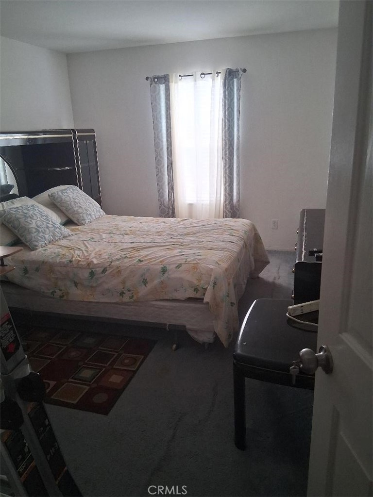 26928 Commons Moreno Valley Moreno Valley, CA 92555 - Photo 9 of 12 a bedroom with a bed and a window