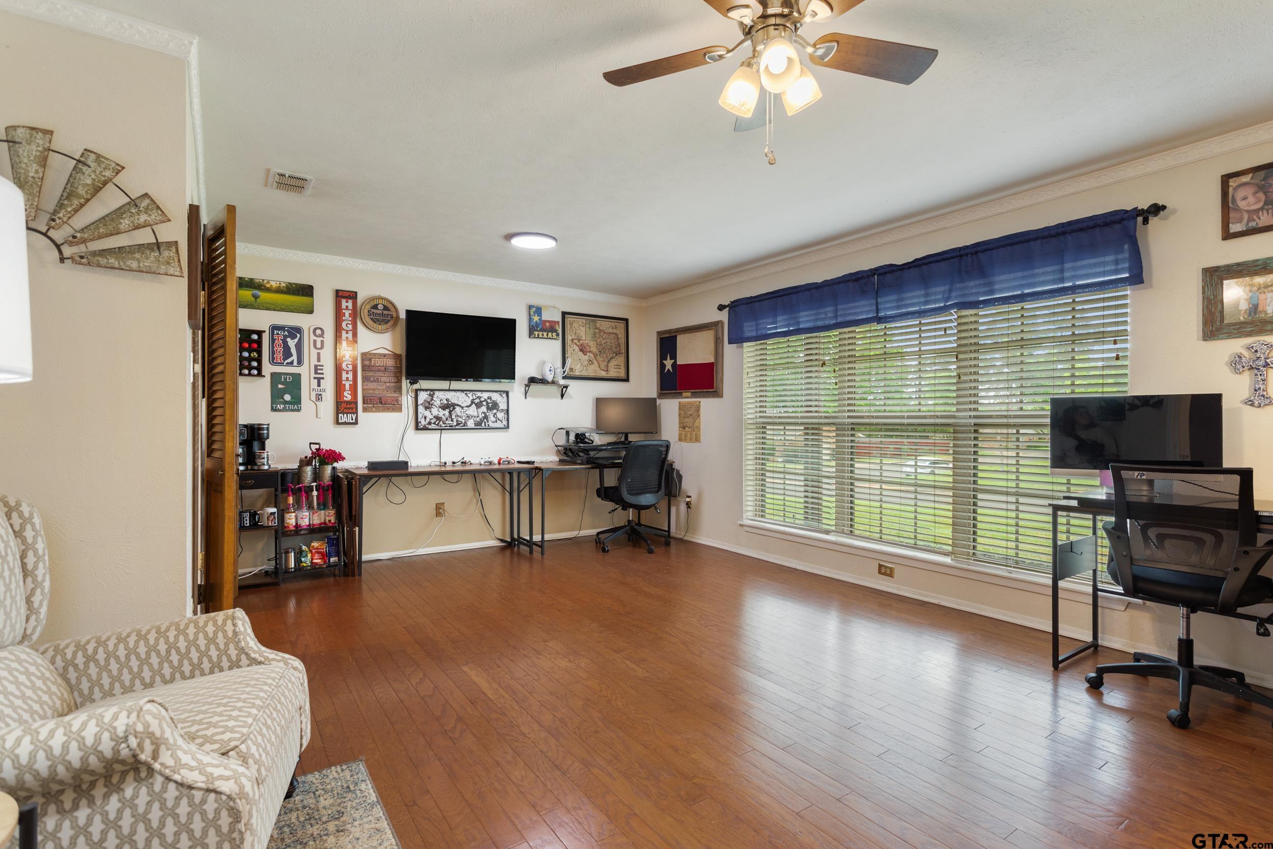 516 Ruthlynn Drive Longview, TX 75605 - Photo 15 of 34 a living room with furniture and a flat screen tv with wooden floor