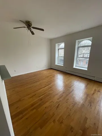 wooden floor in an empty room with a window
