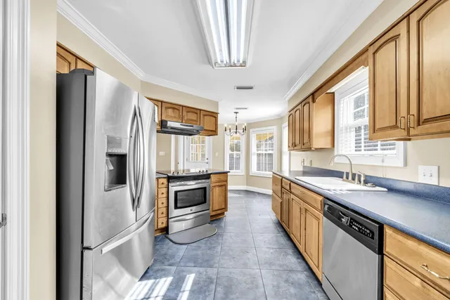 a kitchen with stainless steel appliances granite countertop a stove and a sink