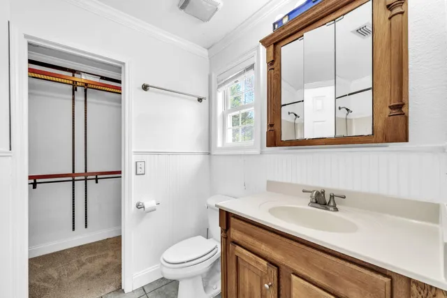 a view of an empty room with a chandelier fan