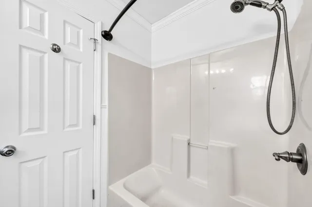 an empty room with windows and ceiling fan