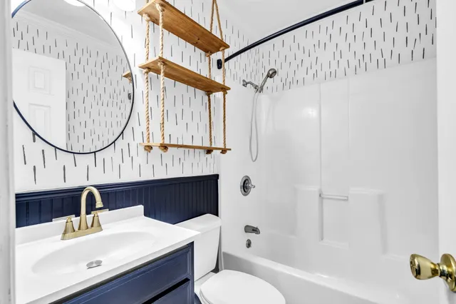 a view of an empty room with window and stairs