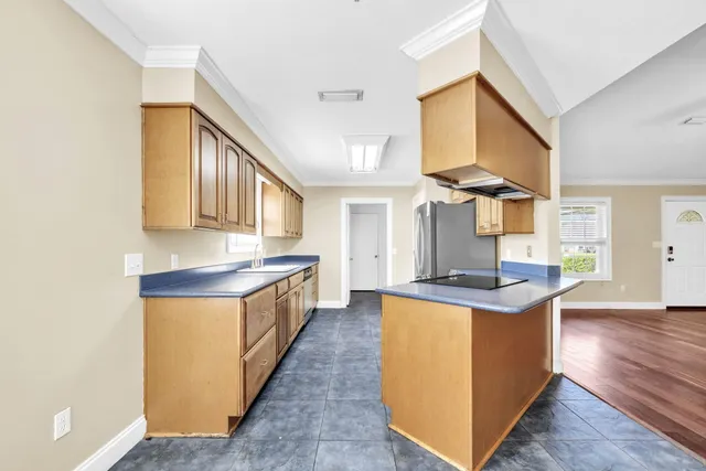 a kitchen with stainless steel appliances a sink stove and cabinets