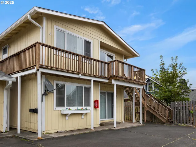 a view of a balcony with wooden floor and city view