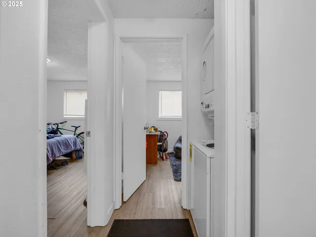 a kitchen with stainless steel appliances a dining table chairs and a refrigerator