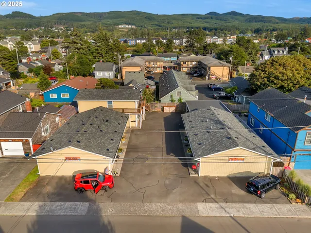 an aerial view of residential houses with outdoor space