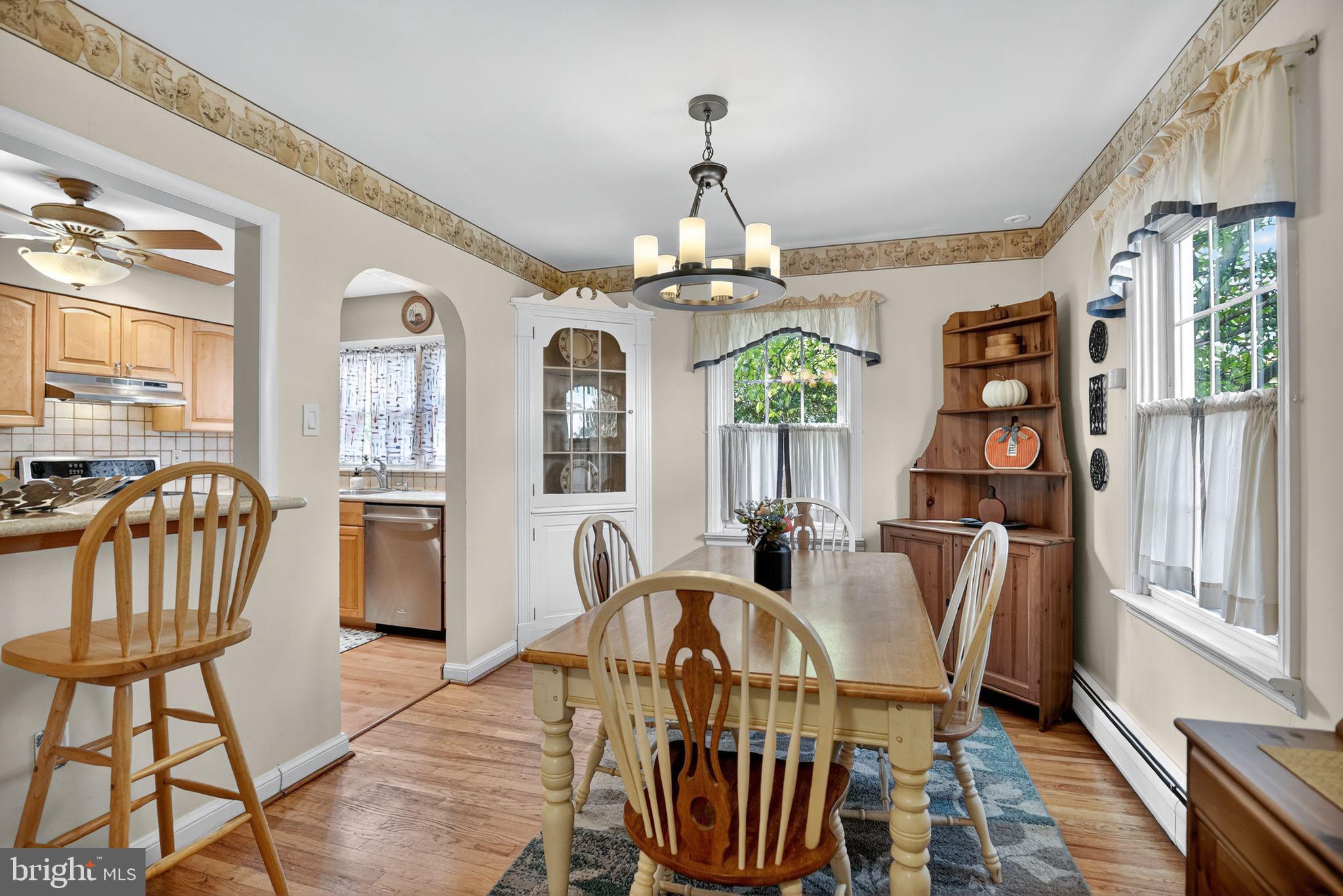 927 Sherman Avenue Huntingdon Valley, PA 19006 - Photo 12 of 29 a view of a dining room with furniture a chandelier and wooden floor