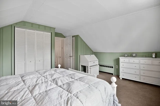 a bedroom with a bed and cabinets