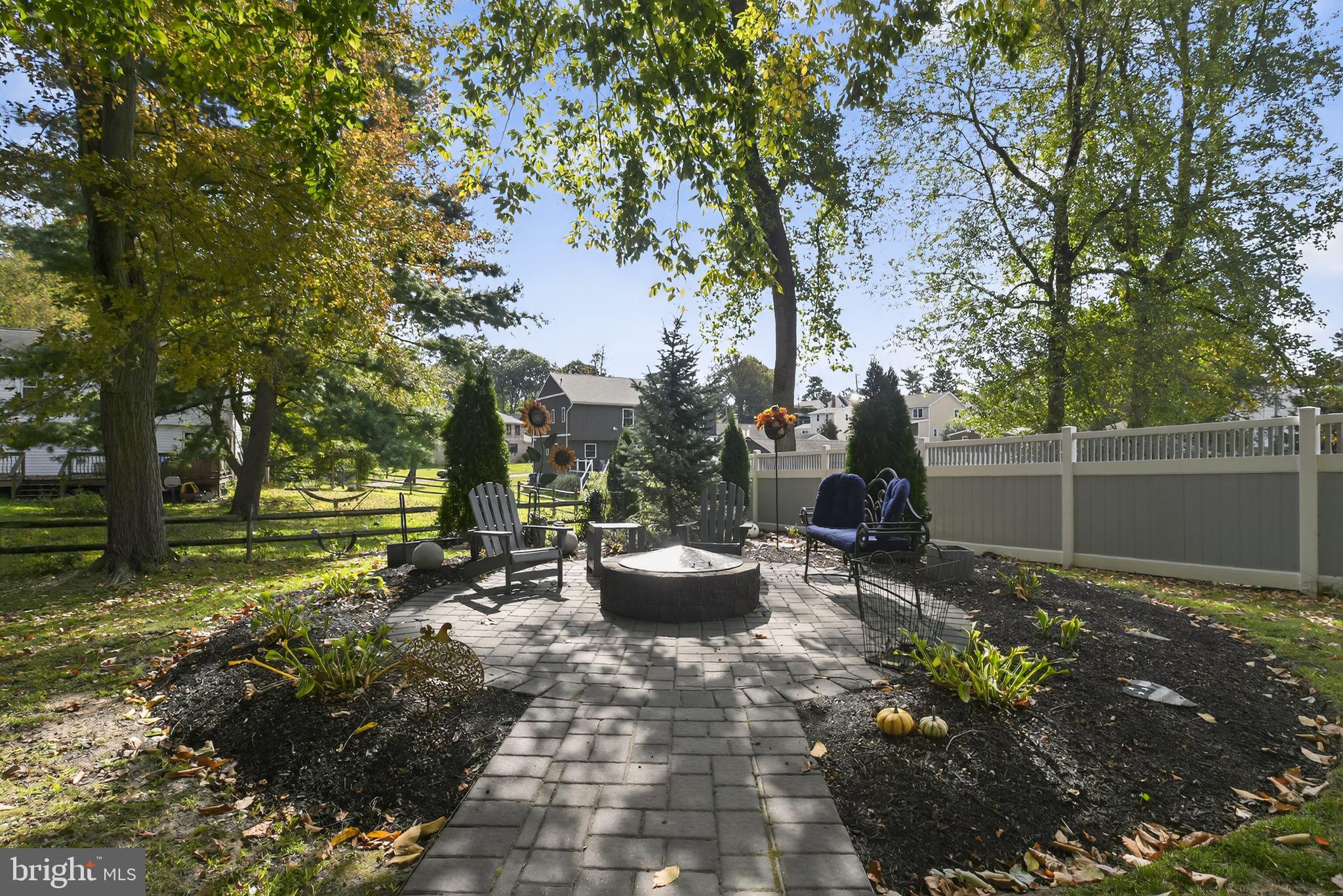 927 Sherman Avenue Huntingdon Valley, PA 19006 - Photo 25 of 29 a view of a backyard with table and chairs potted plants and large tree