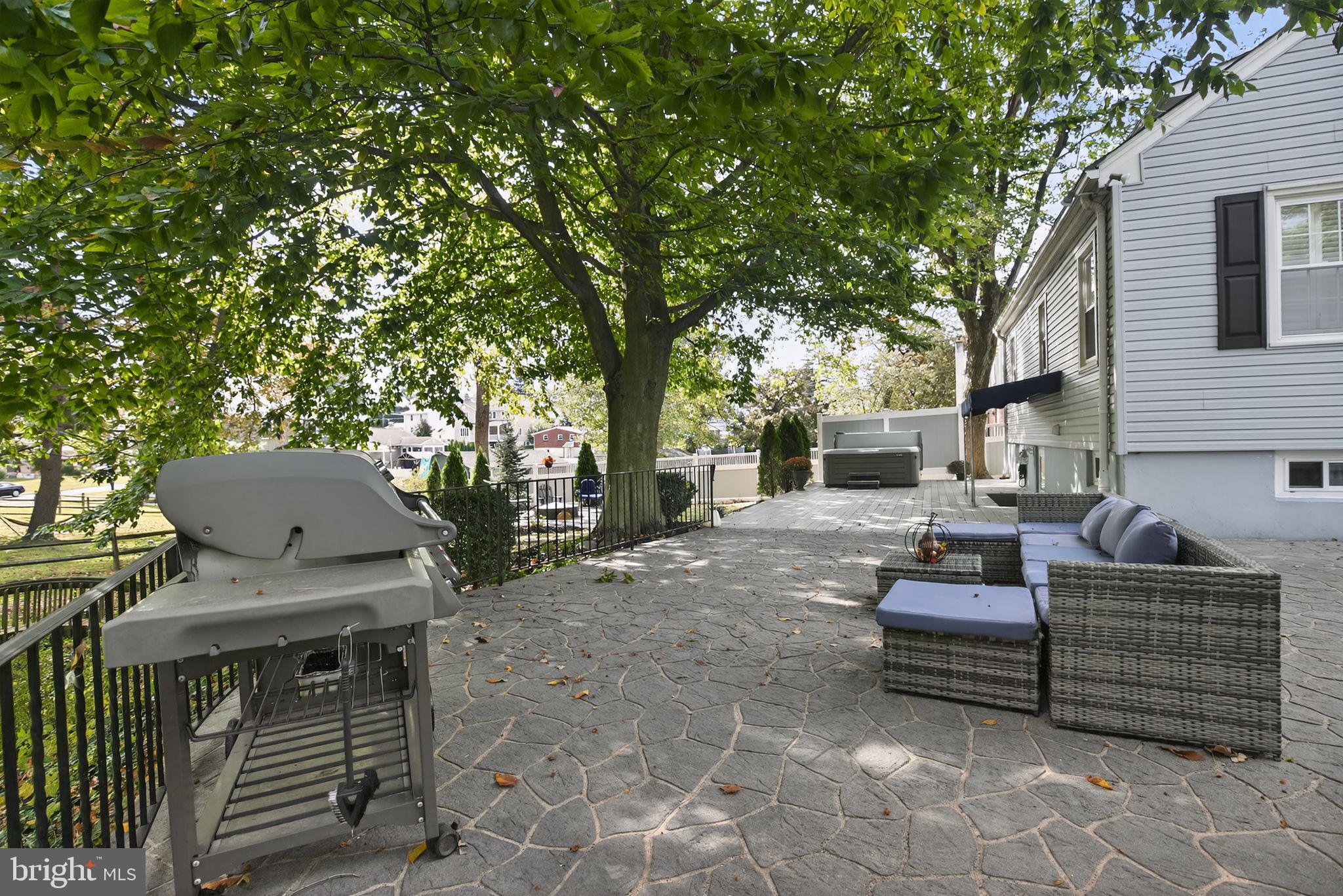 927 Sherman Avenue Huntingdon Valley, PA 19006 - Photo 26 of 29 a view of a patio with table and chairs and a barbeque