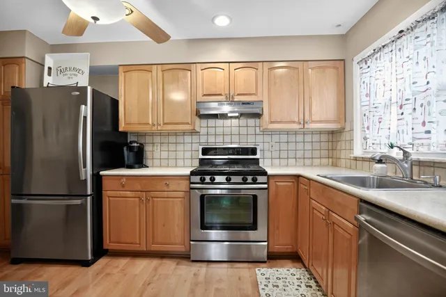 a kitchen with a stove sink and refrigerator