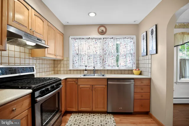 a kitchen that has a sink and a stove