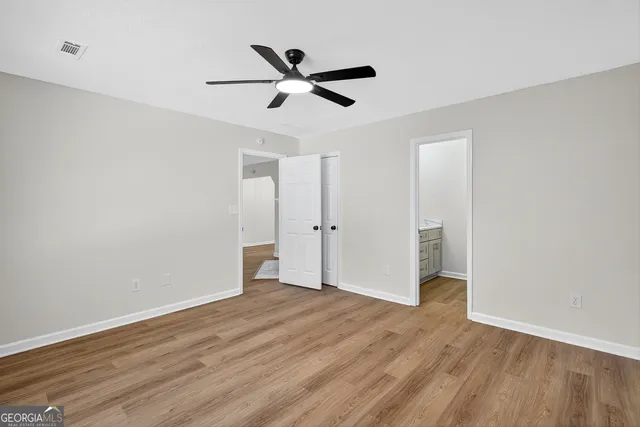 a view of empty room with wooden floor