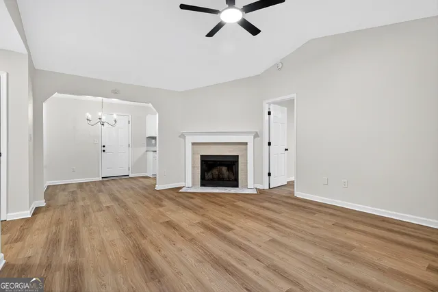 a view of an empty room with a fireplace