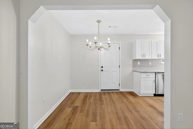 a view of a room with wooden floor