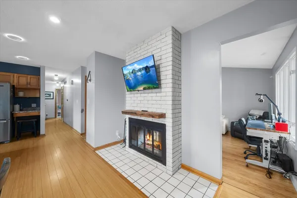 an empty room with fireplace outdoor view and windows