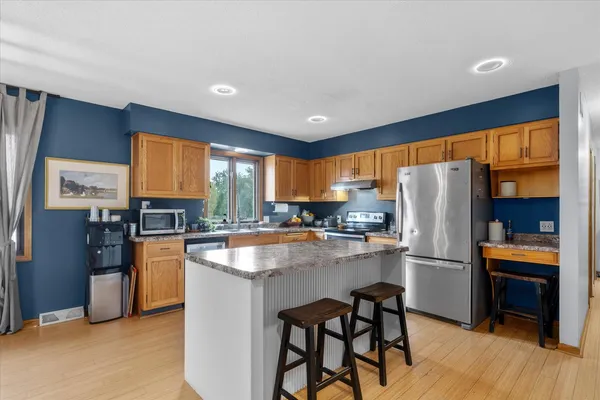 a kitchen with a table and chairs in it