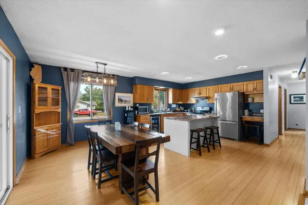 a kitchen with stainless steel appliances granite countertop a stove a sink and a refrigerator