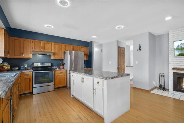 an empty room with fireplace outdoor view and windows