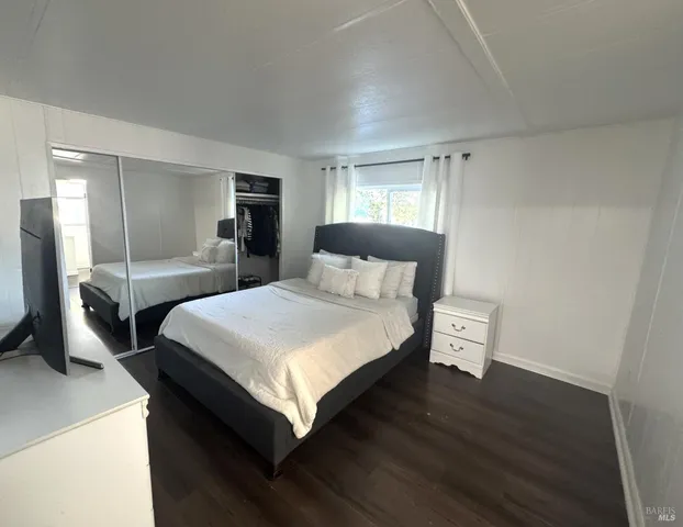 a bedroom with a bed and a night stand