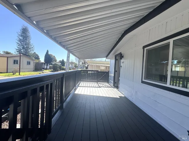 a view of a balcony with wooden floor and staircase