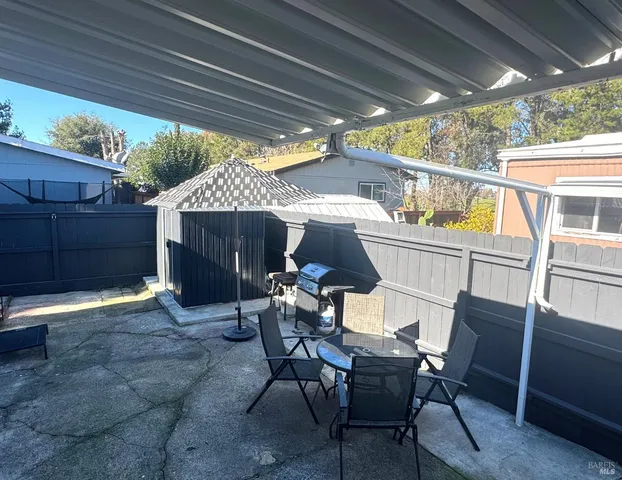 a front view of a house with outdoor seating