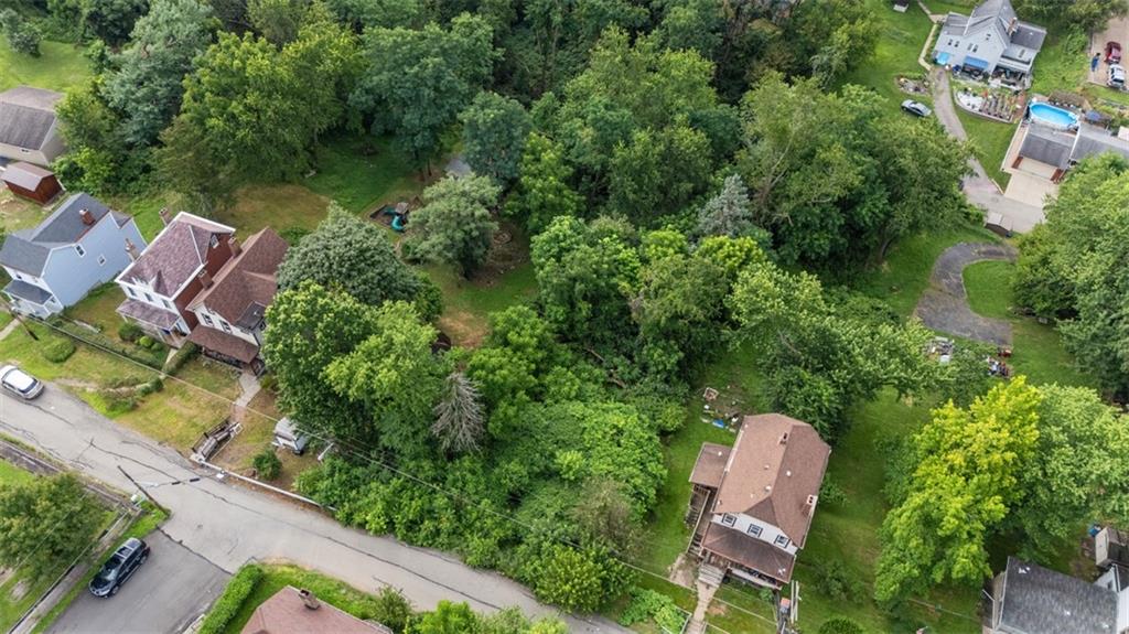 an aerial view of a house with garden space and sitting space