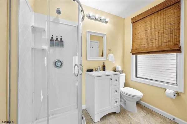 a white toilet sitting next to a bathroom sink