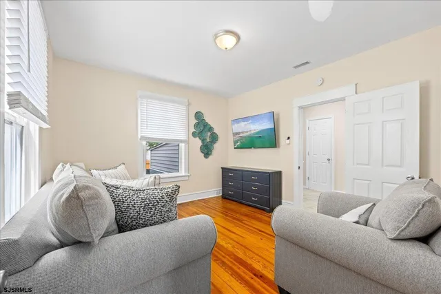 a living room with furniture flat screen tv and a fireplace