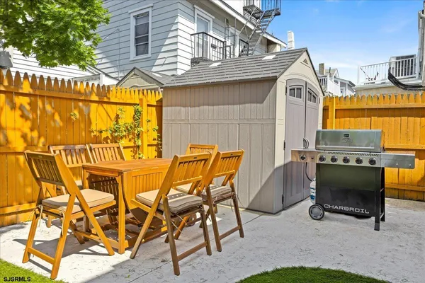 a view of an chairs and table in the patio