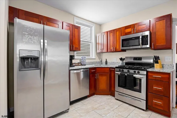 a kitchen with stainless steel appliances granite countertop a refrigerator stove and oven