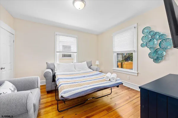 a bedroom with a bed and wooden floor