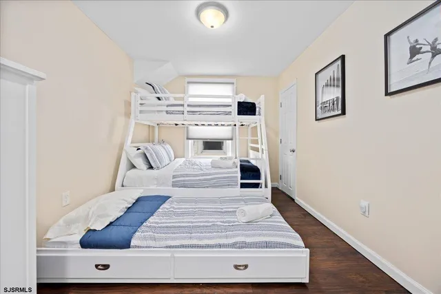 a view of entryway and bedroom with wooden floor