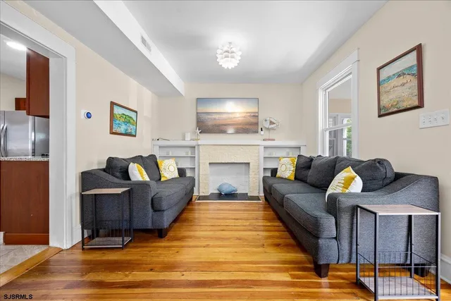 a living room with furniture and a fireplace