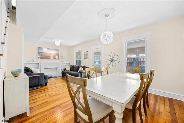 a view of a dining room with furniture and wooden floor
