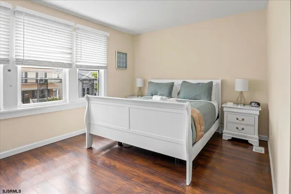 a bedroom with a bed and a large window