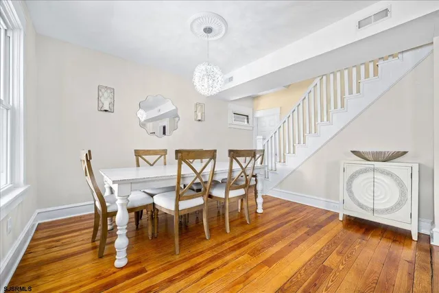 a view of a dining room with furniture and wooden floor