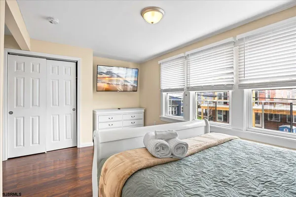 a bedroom with furniture and a large window